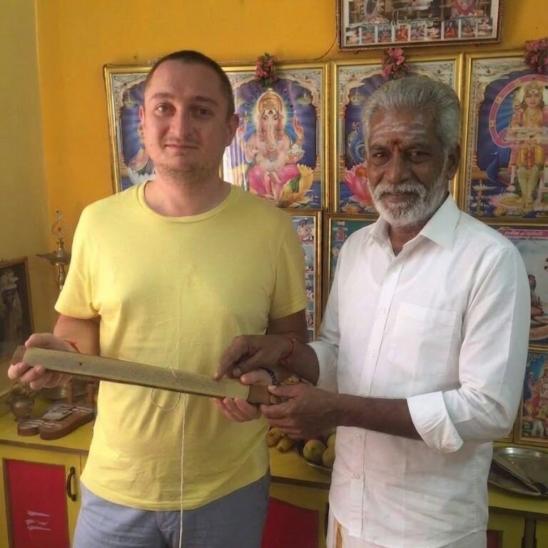 Bulgarian seeker experiencing authentic Nadi palm leaf reading in Tamil Nadu, India. Ancient palm leaves revealing precise life predictions and spiritual guidance with remarkable accuracy.